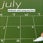Close up of the July page of a green reusable calendar with the words "Undated--start using any time!"
