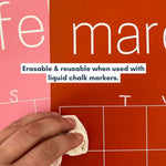 Close up of February and March pages of the rainbow wall calendar with the graphic "Erasable & reusable when used with liquid chalk markers."
