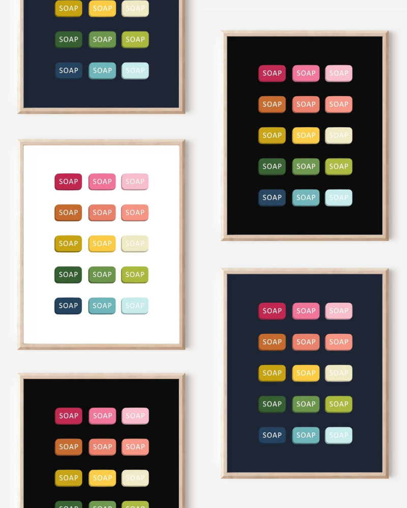 Framed art prints featuring minimalist illustrations of Bars of Soap in rainbow hues on black, navy blue and white backgrounds.