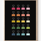 Modern art print of colorful binder clips in rainbow hues arranged in a minimalist grid on a black background.
