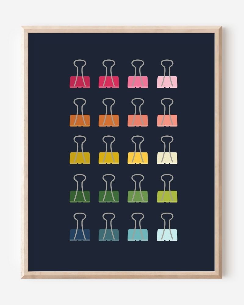 Modern art print of colorful binder clips in rainbow hues arranged in a minimalist grid on a navy background.