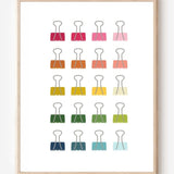 Modern art print of colorful binder clips in rainbow hues arranged in a minimalist grid on a white background.