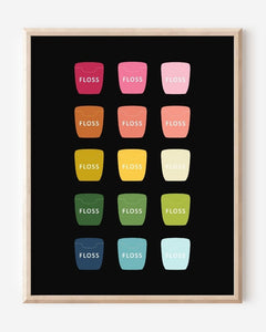 Bathroom wall art print of dental floss containers in rainbow hues arranged in a modern grid on black background.
