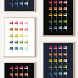 Framed art prints featuring minimalist illustrations of Hand Mixers in rainbow hues on black, navy blue and white backgrounds.