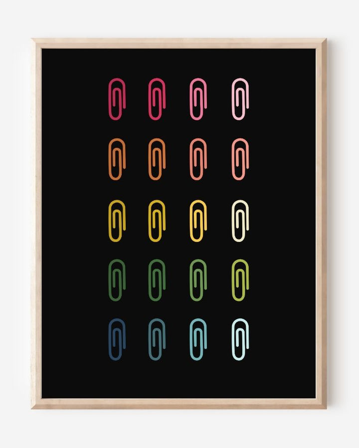 Minimalist modern wall art print featuring colorful paper clips in rainbow colors arranged neatly in a grid on a black background.