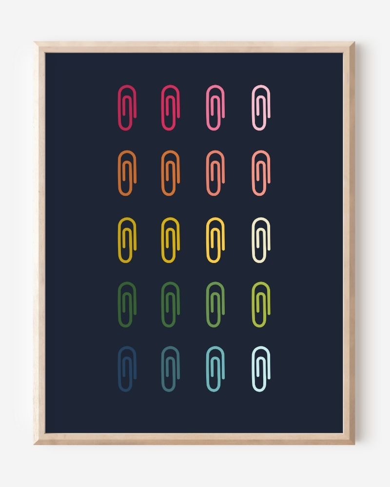 Minimalist modern wall art print featuring colorful paper clips in rainbow colors arranged neatly in a grid on a navy background.