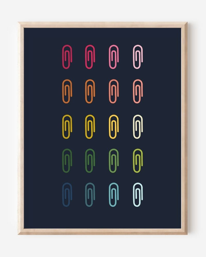 Minimalist modern wall art print featuring colorful paper clips in rainbow colors arranged neatly in a grid on a navy background.