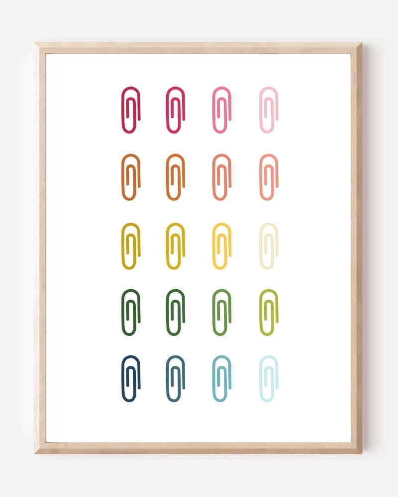 Minimalist modern wall art print featuring colorful paper clips in rainbow colors arranged neatly in a grid on a white background.