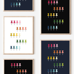 Framed art prints featuring minimalist illustrations of Push Pins in rainbow hues on black, navy blue and white backgrounds.