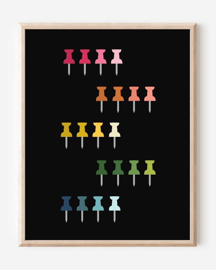 Graphic art print showing colorful push pins in rainbow colors laid out in a clean grid on a black background, playful modern wall art for studios and offices.