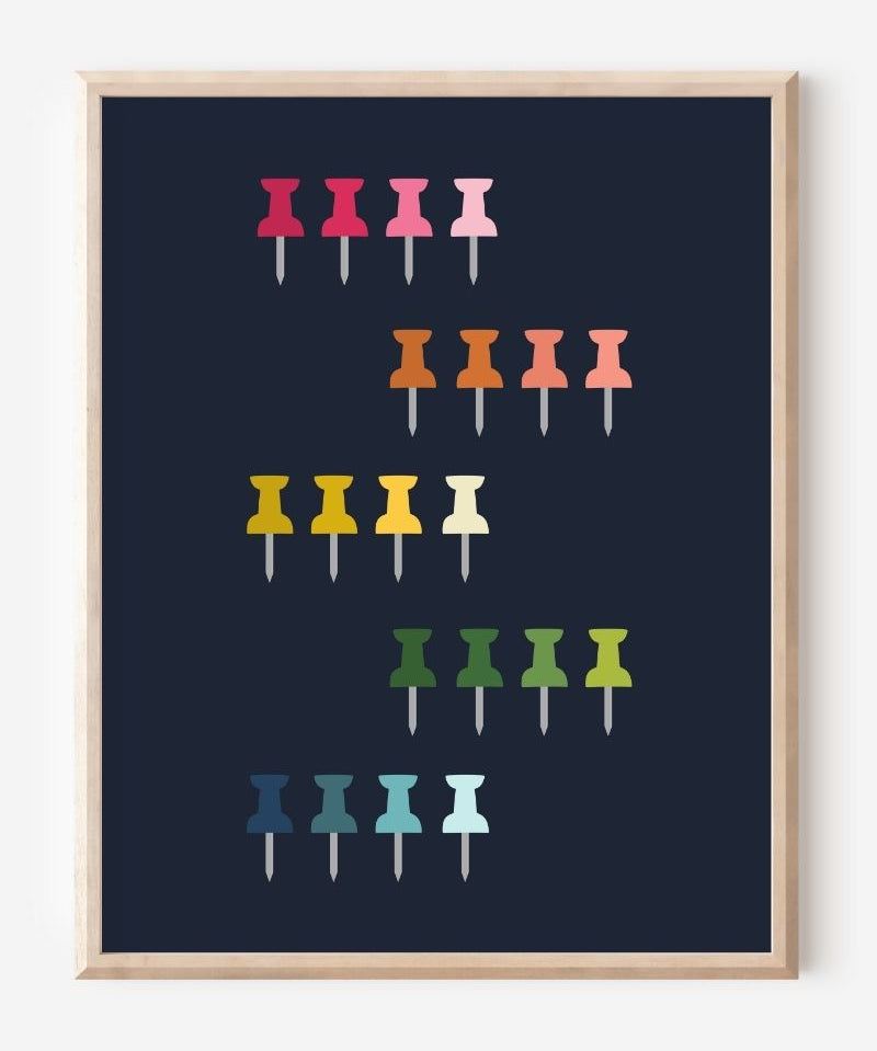 Graphic art print showing colorful push pins in rainbow colors laid out in a clean grid on a navy background, playful modern wall art for studios and offices.