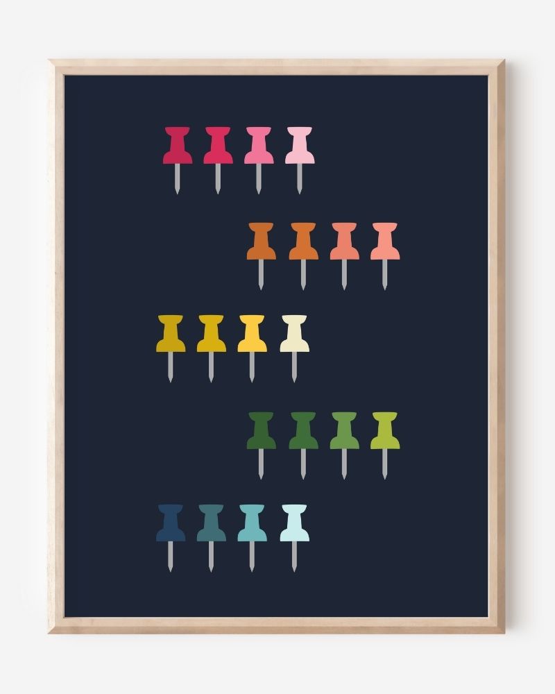Graphic art print showing colorful push pins in rainbow colors laid out in a clean grid on a navy background, playful modern wall art for studios and offices.