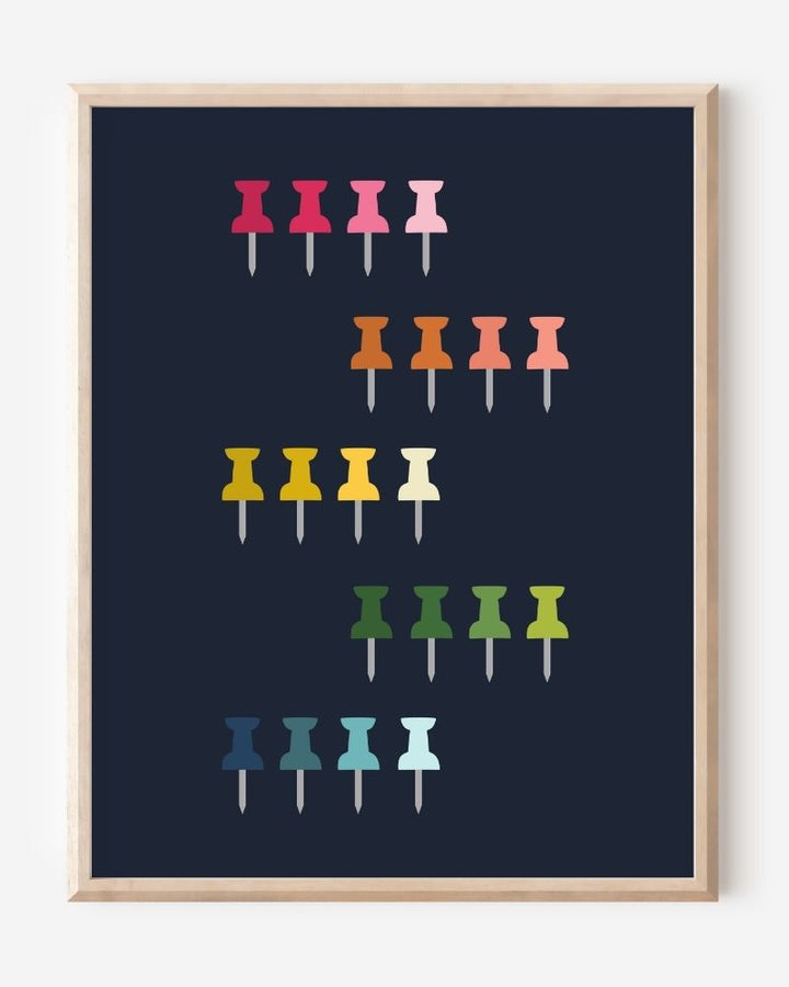Graphic art print showing colorful push pins in rainbow colors laid out in a clean grid on a navy background, playful modern wall art for studios and offices.