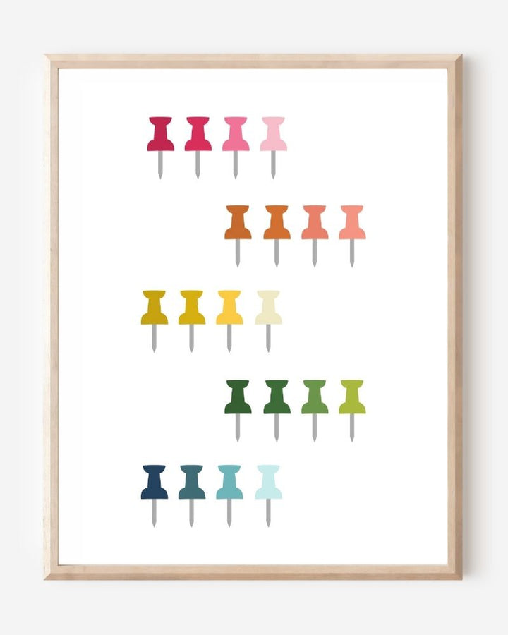 Graphic art print showing colorful push pins in rainbow colors laid out in a clean grid on a white background, playful modern wall art for studios and offices.