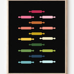 Kitchen wall art featuring rolling pins in ombre rainbow hues arranged in a grid pattern on a black background.