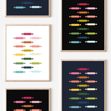Framed art prints featuring minimalist illustrations of Rolling Pins in rainbow hues on black, navy blue and white backgrounds.