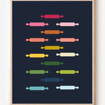 Kitchen wall art featuring rolling pins in ombre rainbow hues arranged in a grid pattern on a blue background.