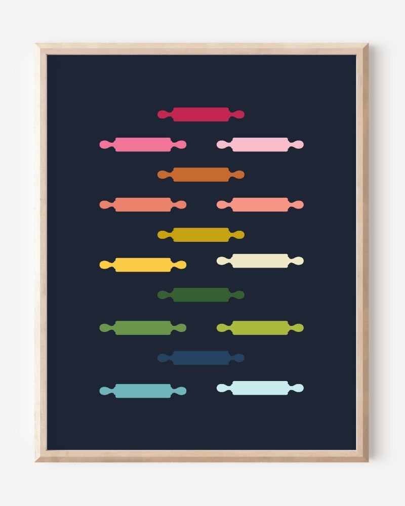 Kitchen wall art featuring rolling pins in ombre rainbow hues arranged in a grid pattern on a blue background.