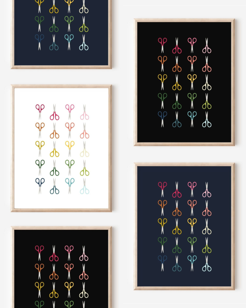 Framed art prints featuring minimalist illustrations of Scissors in rainbow hues on black, navy blue and white backgrounds.