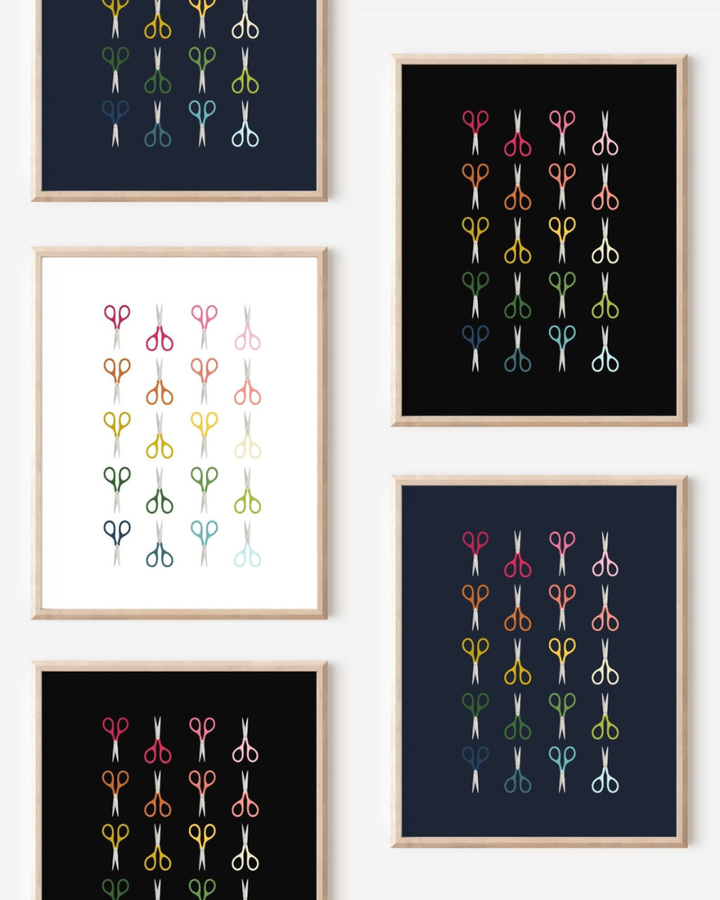 Framed art prints featuring minimalist illustrations of Scissors in rainbow hues on black, navy blue and white backgrounds.