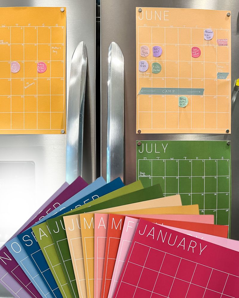 colorful monthly calendar in rainbow hues hanging on refrigerator