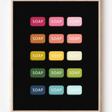 Graphic art print of bars of soap in rainbow hues arranged in neat rows on black background.