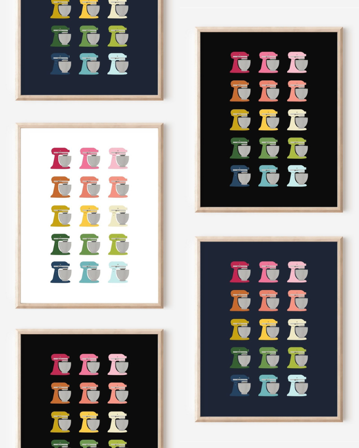 Framed art prints featuring minimalist illustrations of Stand Mixers in rainbow hues on black, navy blue and white backgrounds.