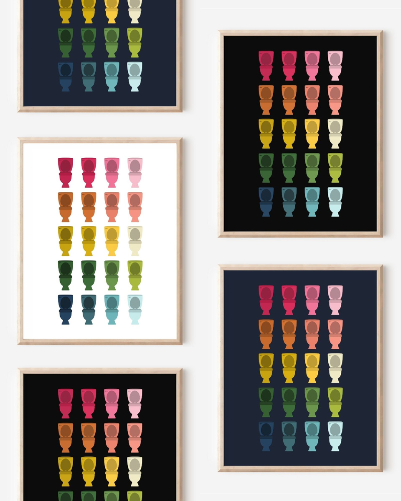 Framed art prints featuring minimalist illustrations of Toilets in rainbow hues on black, navy blue and white backgrounds.