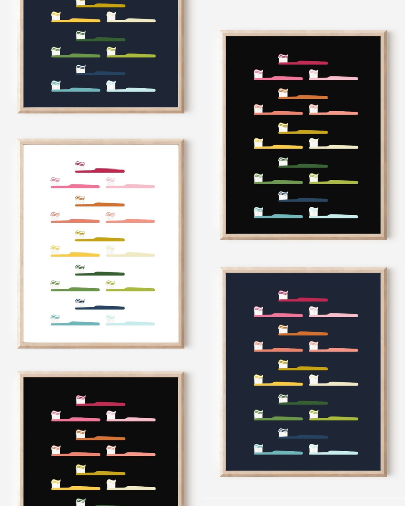 Framed art prints featuring minimalist illustrations of Toothbrushes in rainbow hues on black, navy blue and white backgrounds.