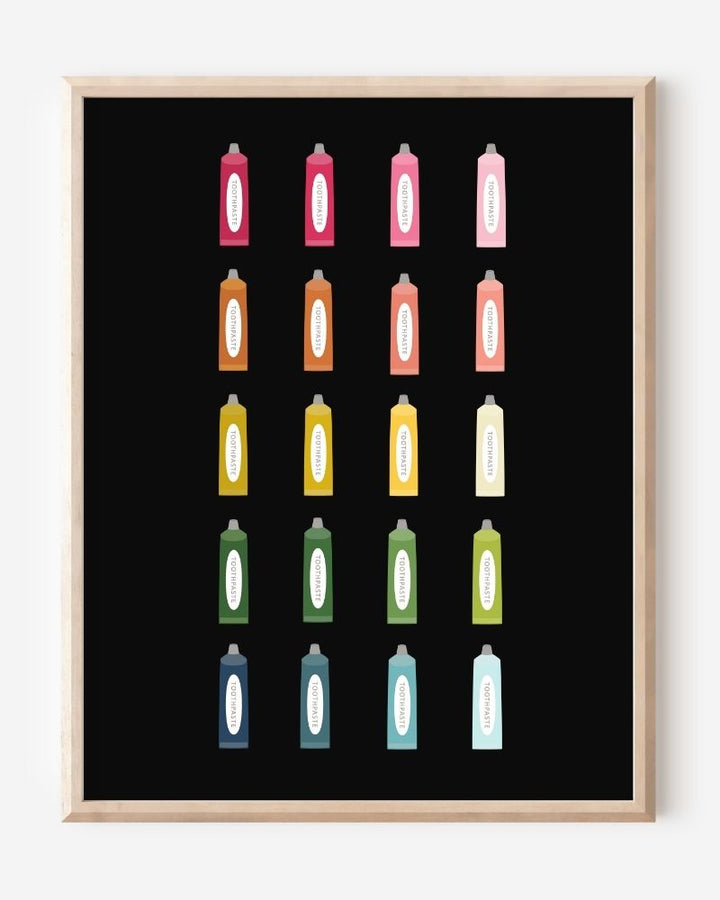 Minimalist bathroom wall art print showing colorful toothpaste tubes in a grid on a black background.