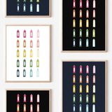 Framed art prints featuring minimalist illustrations of Toothpaste in rainbow hues on black, navy blue and white backgrounds.