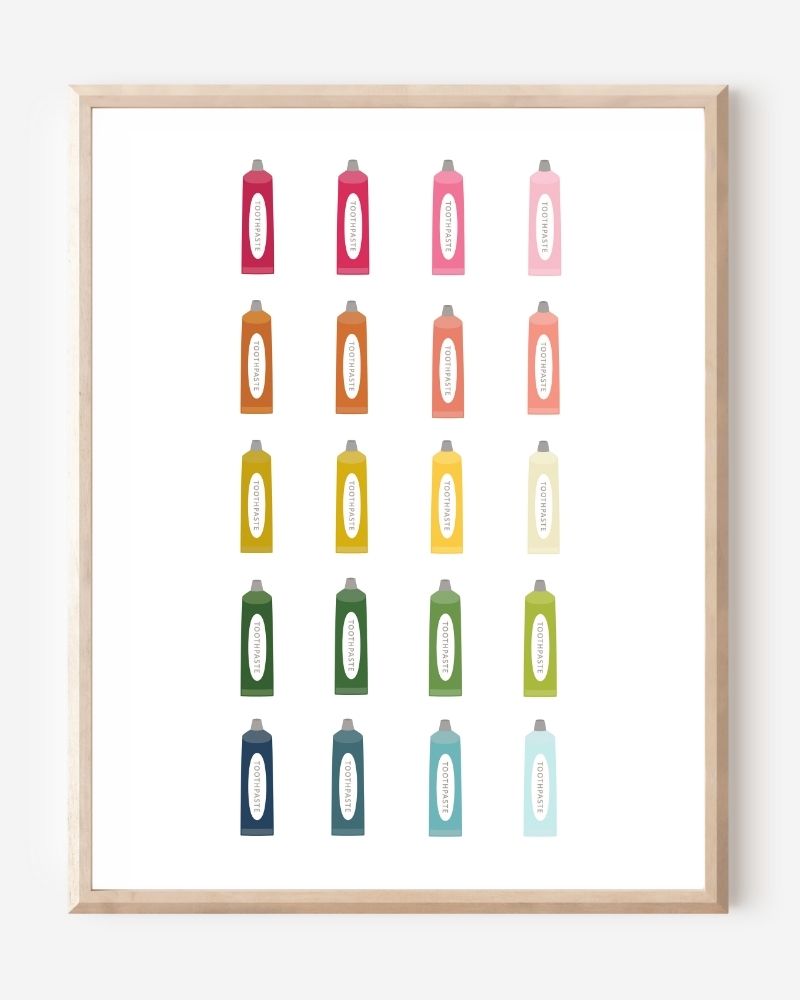 Minimalist bathroom wall art print showing colorful toothpaste tubes in a grid on a white background.