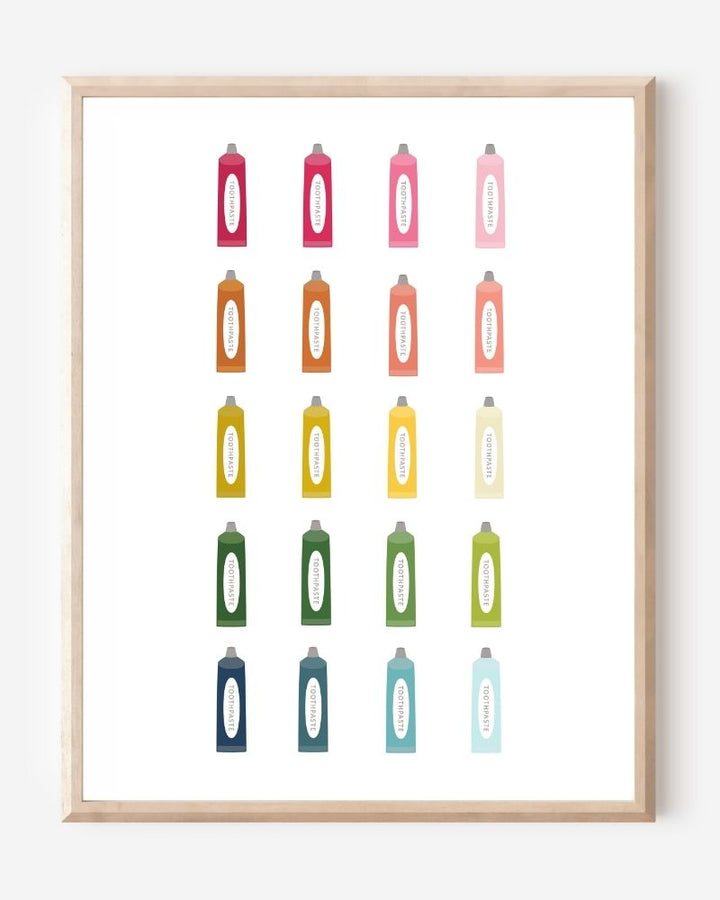Minimalist bathroom wall art print showing colorful toothpaste tubes in a grid on a white background.