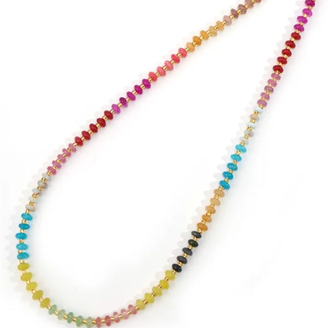 A delicate necklace with petite natural stone beads in vibrant sunset hues, strung together with gold accents.