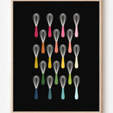 Kitchen wall art showing simple graphic whisks in ombre rainbow hues arranged in rows on a black background.