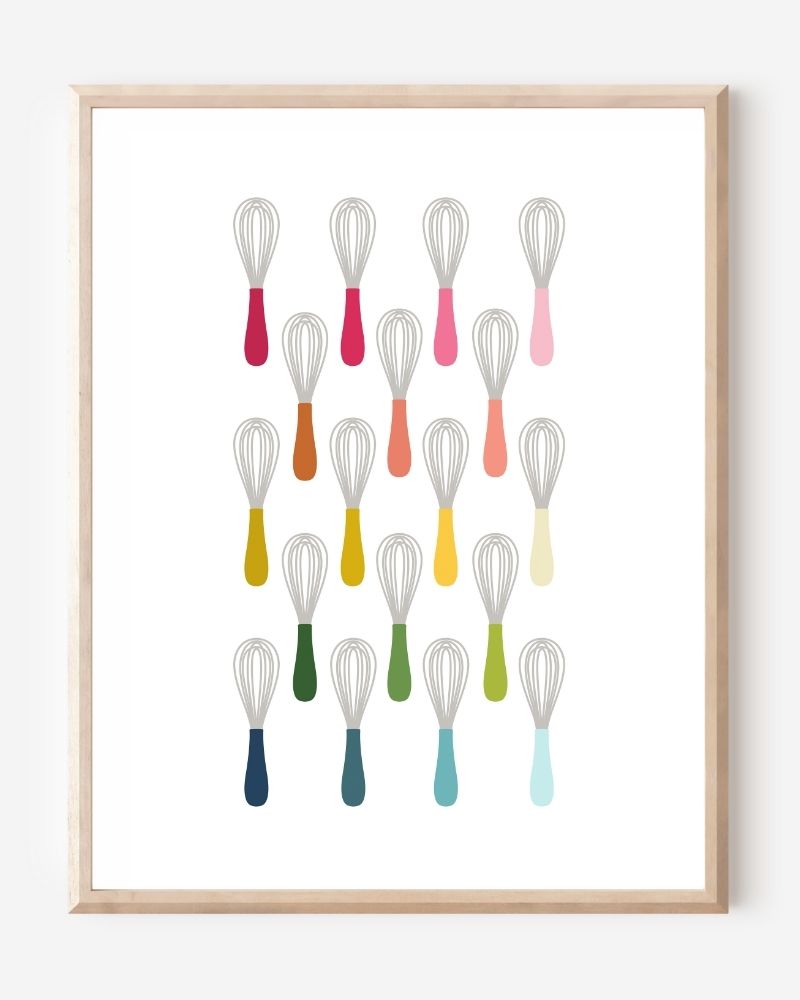 Kitchen wall art showing simple graphic whisks in ombre rainbow hues arranged in rows on a white background.