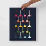 bathroom art with a navy background and grid of colorful graphic toilet plungers in ombre rainbow colors ranging from pinks to blues