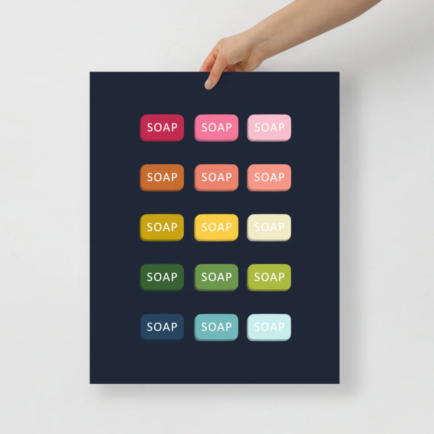 bathroom art with a navy background and grid of colorful graphic bards of soap in ombre rainbow colors ranging from pinks to blues