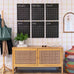 Large reusable black calendar on a wall with a wooden cabinet below and colorful decor items around.