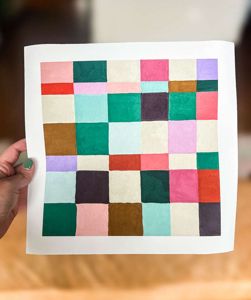 hand holding colorful checkerboard abstract art print from Kaleidoscope Living Shop