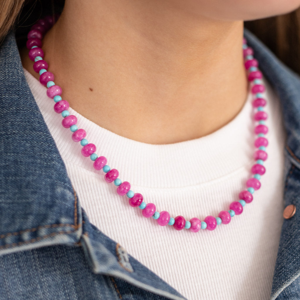 Girl wearing a fuchsia and blue stone necklace