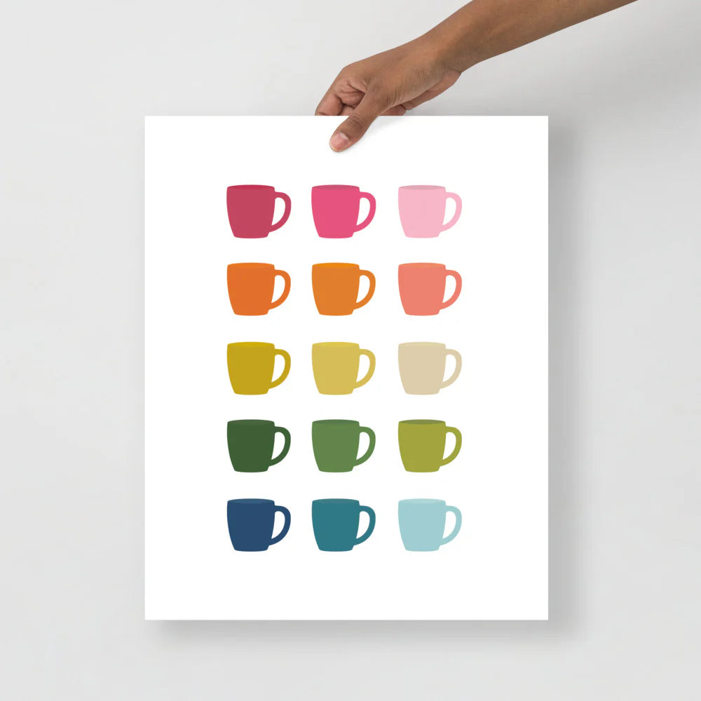 kitchen art print with a white background and grid of colorful clip art of coffee mugs in ombre rainbow colors ranging from pinks to blues