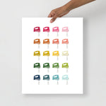 kitchen art print with a white background and grid of colorful clip art of hand mixers in ombre rainbow colors ranging from pinks to blues