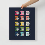 kitchen art print with a navy background and grid of colorful clip art of stand mixers in ombre rainbow colors ranging from pinks to blues