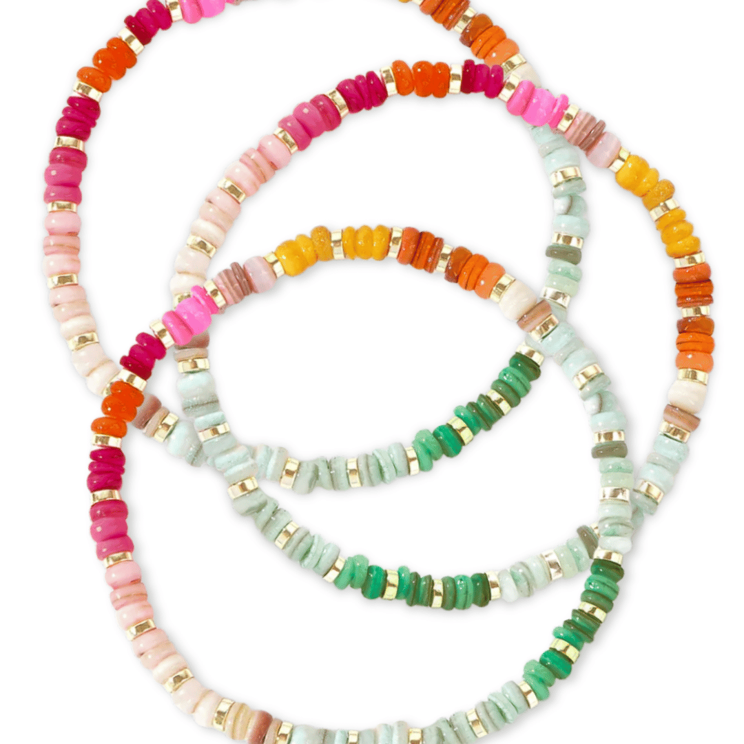 set of rainbow beaded stretch bracelets on white background