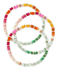 set of rainbow beaded stretch bracelets on white background