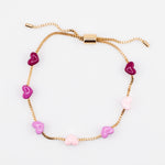 Adjustable gold chain bracelet with pink enamel hearts from Kaleidoscope Living.