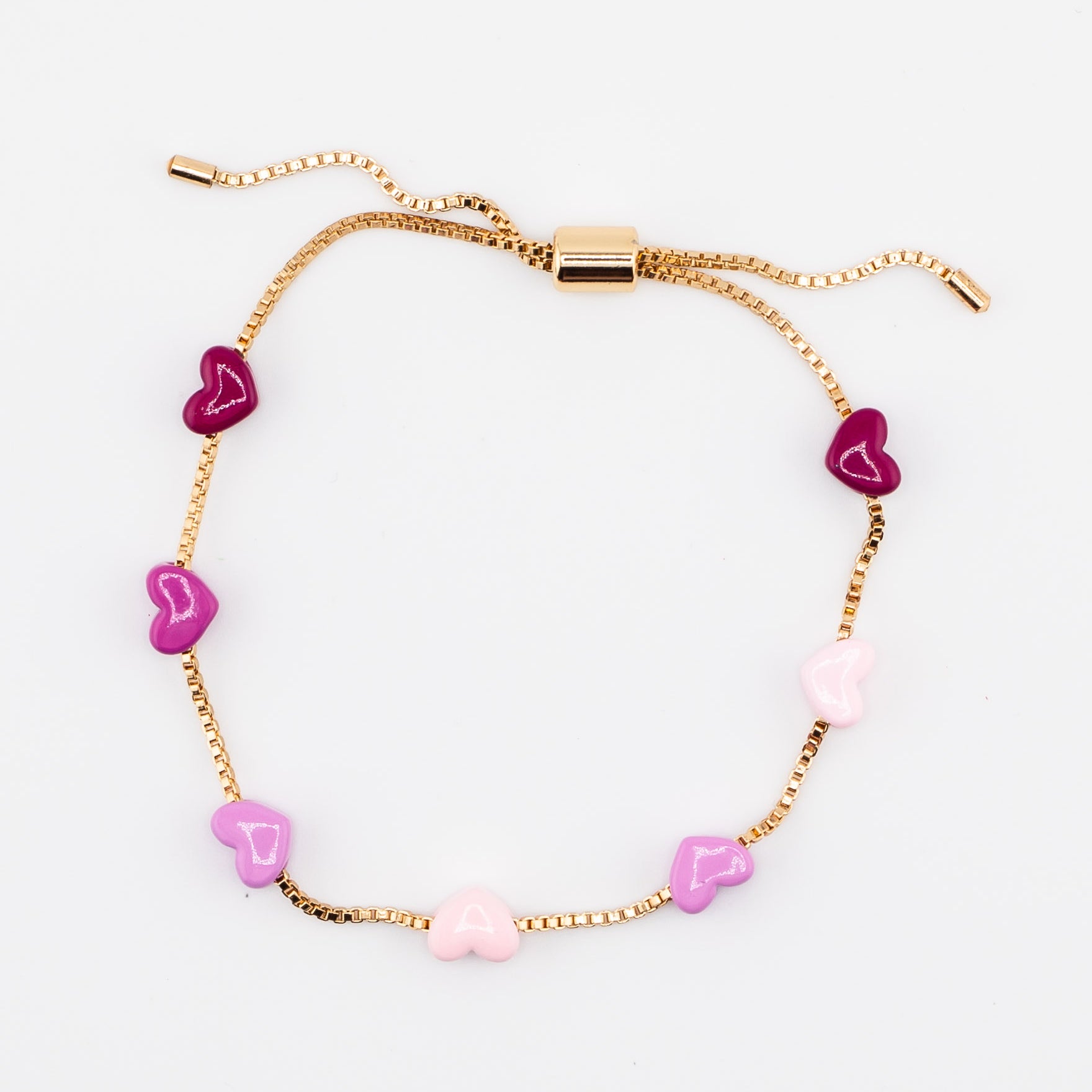 Adjustable gold chain bracelet with pink enamel hearts from Kaleidoscope Living.
