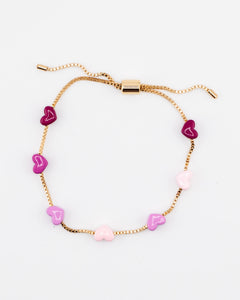 Adjustable gold chain bracelet with pink enamel hearts from Kaleidoscope Living.