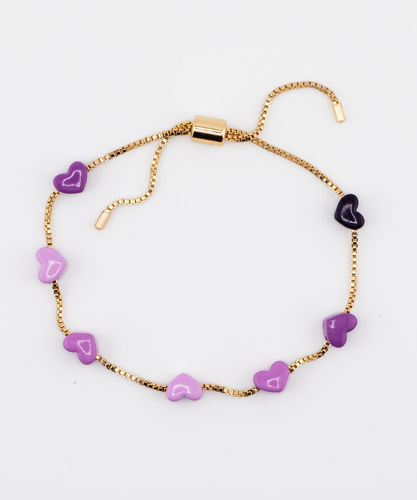 Gold adjustable bracelet with purple enamel hearts on a white background